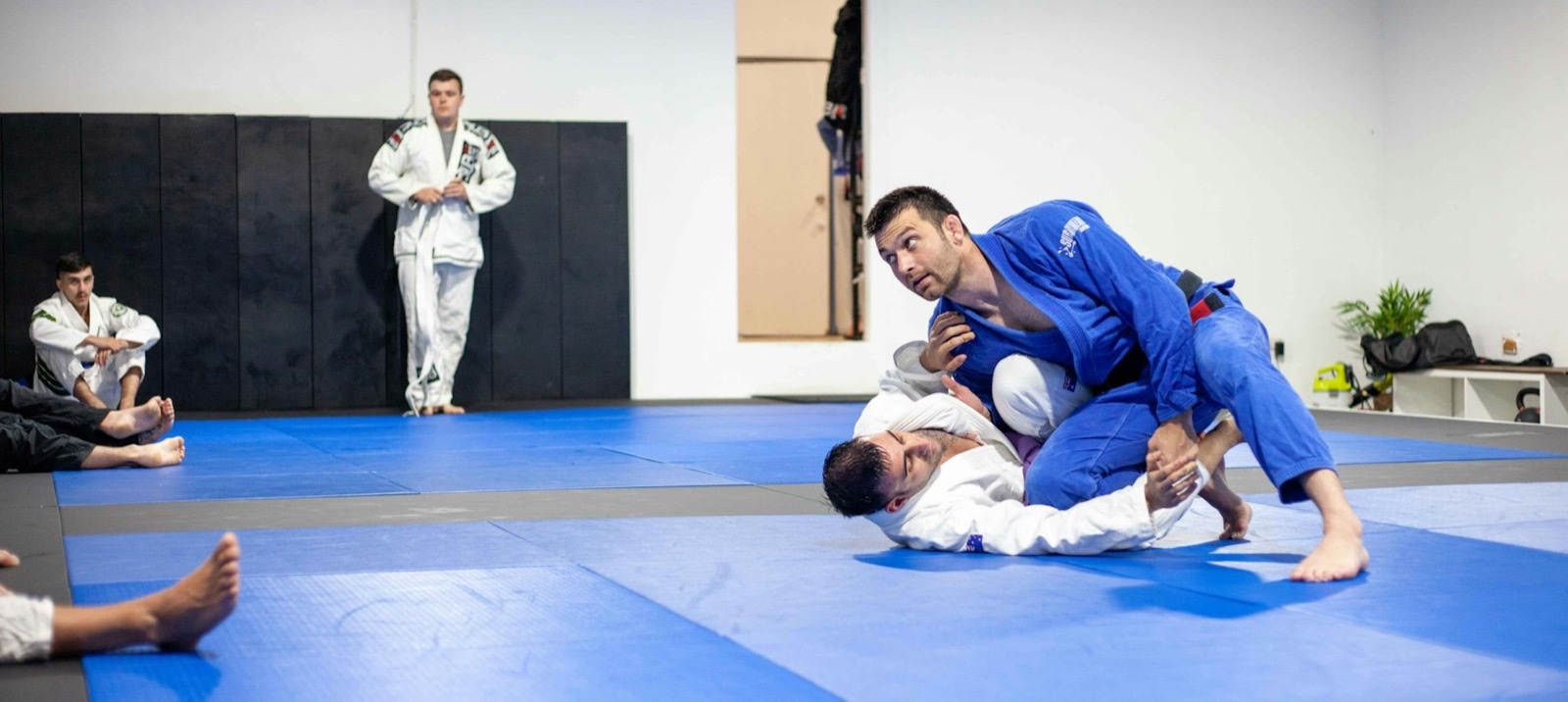 Two athletes drilling on the mats