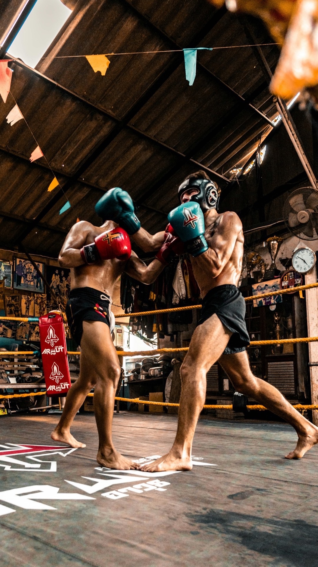 Two boxers sparring in a gym